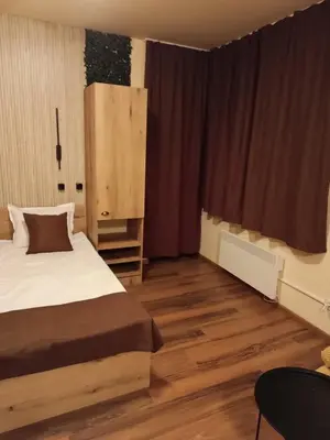 a bedroom with a bed and a wooden floor at Апартаменти Pamporovo Dream в Гранд Ризорт Пампорово in Pamporovo