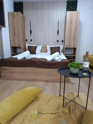 a bedroom with a large bed and a table at Апартаменти Pamporovo Dream в Гранд Ризорт Пампорово in Pamporovo