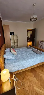 a large bed in a room with a wooden floor at Elegant and cozy apartment in Sofia