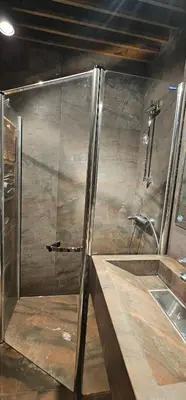 a shower with a glass door in a bathroom at Elegant and cozy apartment in Sofia