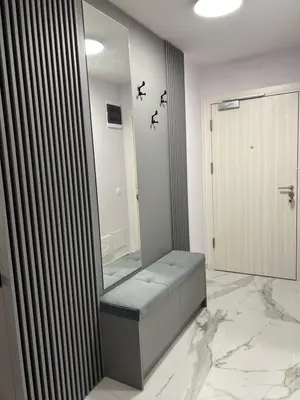 a bathroom with a bench in front of a mirror at Center Park Apartment in Sandanski