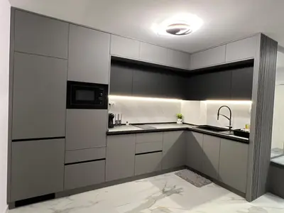a kitchen with white cabinets and a sink at Center Park Apartment in Sandanski