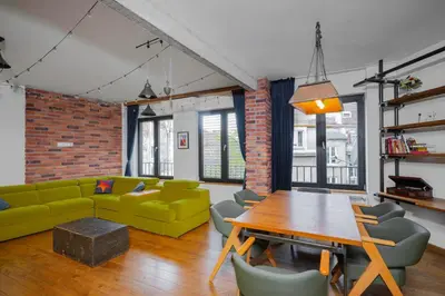 a living room with a green couch and a table at Central Sanctuary 3BD by Flat Mаnаger in Sofia