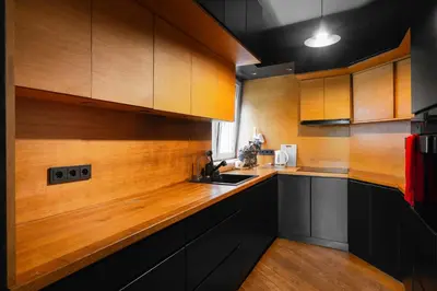 a kitchen with wooden cabinets and a counter top at Central Sanctuary 3BD by Flat Mаnаger in Sofia