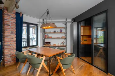 a dining room with a wooden table and chairs at Central Sanctuary 3BD by Flat Mаnаger in Sofia