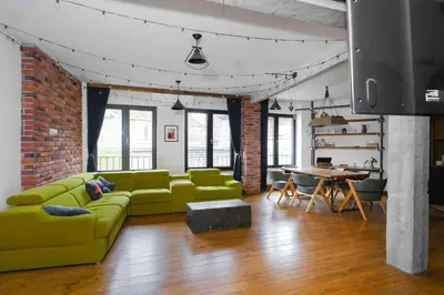 a living room with a green couch and a table at Central Sanctuary 3BD by Flat Mаnаger in Sofia