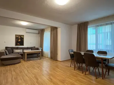 a living room with a couch and a table and chairs at Victoria apartment - Sandanski in Sandanski