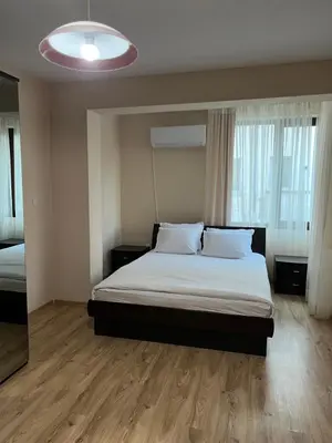 a bedroom with a bed and a large window at Victoria apartment - Sandanski in Sandanski