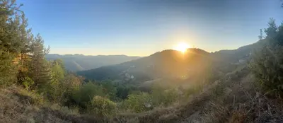 a view of the sun setting on a mountain at Ta Petrina Cottage in Selishte