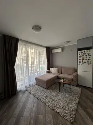 a living room with a couch and a table at Tanov Cozy Place in Blagoevgrad