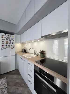 a kitchen with white cabinets and a white refrigerator at Tanov Cozy Place in Blagoevgrad