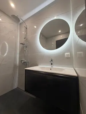 a bathroom with a sink and a mirror at DomBox Sofia Suites - Stylish 2 Bedroom in Center - Free Garage in Sofia