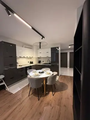 a kitchen and dining room with a table and chairs at DomBox Sofia Suites - Stylish 2 Bedroom in Center - Free Garage in Sofia