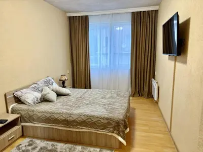 a hotel room with a bed and a television at Guest House Mihalkovo in Mikhalkovo