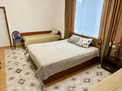 a bedroom with two beds and a window at Guest House Mihalkovo in Mikhalkovo