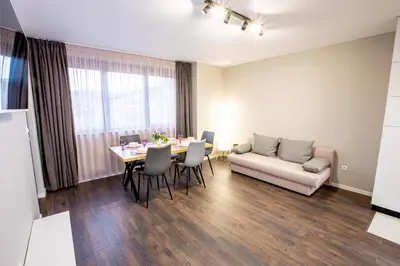 a living room with a table and a couch at Saphi Apt in Sandanski