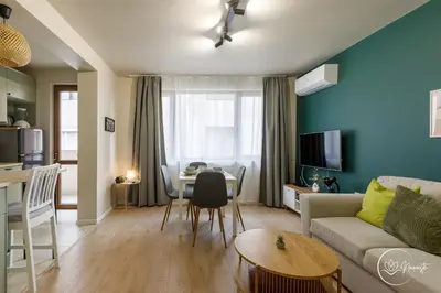 a living room with a couch and a table at Namaste apartment - cozy, central and relaxing stay near AUBG, freshly renovated in Blagoevgrad