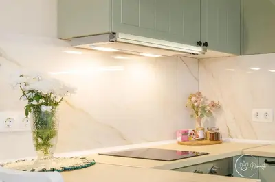 a kitchen with a vase of flowers on a counter at Namaste apartment - cozy, central and relaxing stay near AUBG, freshly renovated in Blagoevgrad