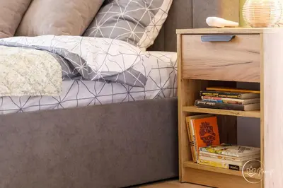 a bed and a bookcase next to a bed with a bed sqor at Namaste apartment - cozy, central and relaxing stay near AUBG, freshly renovated in Blagoevgrad