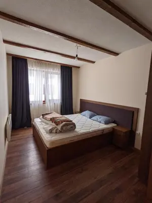 a bedroom with a large bed in a room at Lovely 1-bedroom Apartment with Mountain View in Bansko
