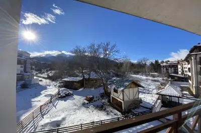 a view from a balcony with snow on the ground at Lovely 1-bedroom Apartment with Mountain View in Bansko
