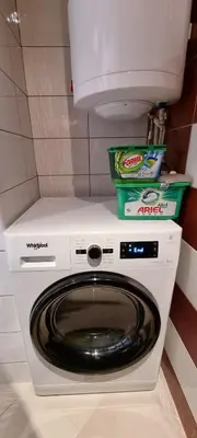 a washer and dryer in a bathroom with a toilet at Lovely 1-bedroom Apartment with Mountain View in Bansko