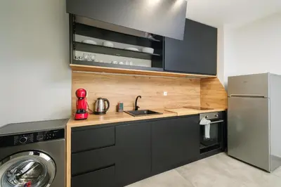 a kitchen with a sink and a refrigerator at Quiet & Comfy 1BR in the Heart of Plovdiv with Private Balcony in Plovdiv