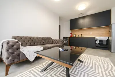 a living room with a couch and a table at Quiet & Comfy 1BR in the Heart of Plovdiv with Private Balcony in Plovdiv