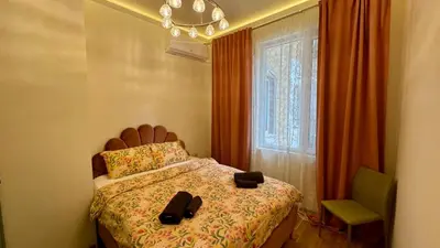 a bedroom with a bed with a pair of shoes on it at 2 Bedrooms Top Central Apartment on Vitosha Boulevard in Sofia
