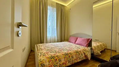 a small bedroom with a bed and a window at 2 Bedrooms Top Central Apartment on Vitosha Boulevard in Sofia