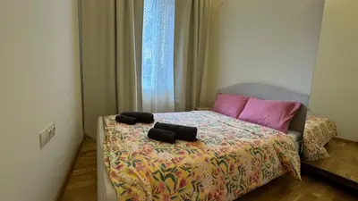 a bedroom with a bed with two black towels on it at 2 Bedrooms Top Central Apartment on Vitosha Boulevard in Sofia