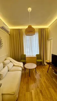 a living room with a couch and a table at 2 Bedrooms Top Central Apartment on Vitosha Boulevard in Sofia