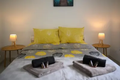 a large bed with two lamps on top of it at Top Center - 2 min from NDK in Sofia