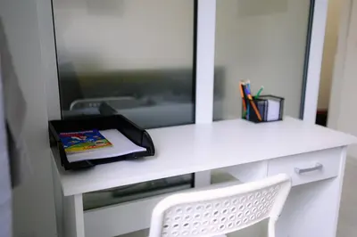 a white desk with a mirror and a book on it at Top Center - 2 min from NDK in Sofia