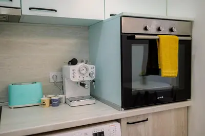 a kitchen with a coffee maker and a microwave at Top Center - 2 min from NDK in Sofia