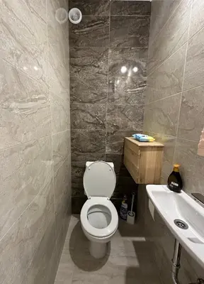 a bathroom with a toilet and a sink at Cozy Home 2 Bedroom apartment in Kyustendil