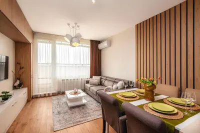 a living room with a couch and a dining room table at Brand New Luxury Apartments with Great Views in Sofia