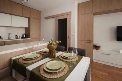 a dining room with a table with plates and glasses at Brand New Luxury Apartments with Great Views in Sofia