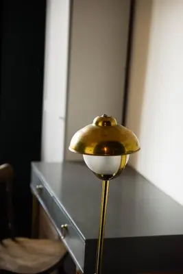 a brass lamp sitting on top of a table at Wonderland Rooms for Rent in Sofia