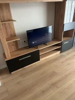 a living room with a flat screen tv on a entertainment center at Cozy and comfortable panorama park Entrance E not K in Plovdiv
