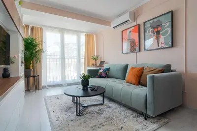 a living room with a couch and a table at Maison Colorée - Bright And Cozy Home by Metro And Mall in Sofia