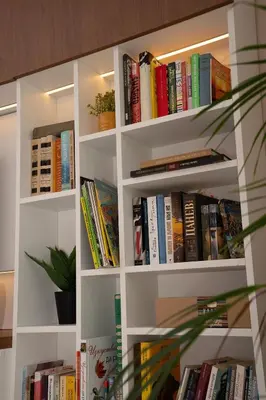 a book shelf filled with lots of books at Maison Colorée - Bright And Cozy Home by Metro And Mall in Sofia