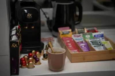 a counter top with a cup and a coffee maker at Maison Colorée - Bright And Cozy Home by Metro And Mall in Sofia