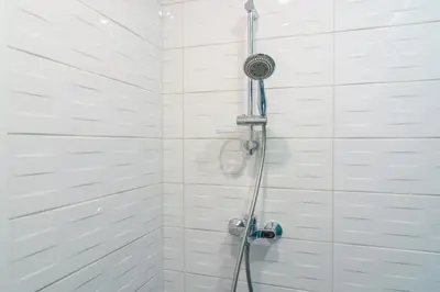a shower with a shower head in a bathroom at Maison Colorée - Bright And Cozy Home by Metro And Mall in Sofia