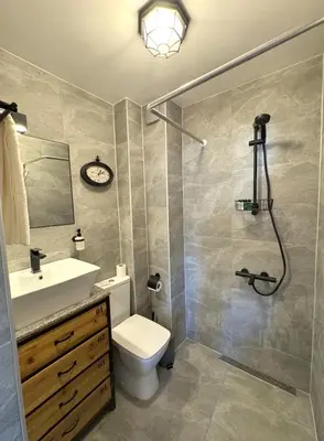 a bathroom with a toilet and a sink and a shower at Cozy Home In Central Plovdiv in Plovdiv
