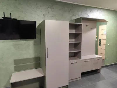 a large white cabinet with a tv on a wall at RCR Einstein studios 3 in Sofia