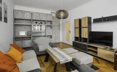a living room with a couch and a flat screen tv at The Cosmopolitan Shine 1-BDR Pet-Friendly Flat in Sofia