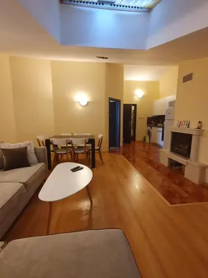 a living room with a couch and a table at Apartment Sunny in Pamporovo