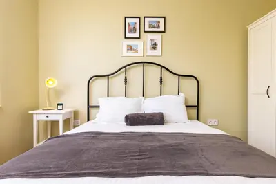 a bedroom with a large bed with white pillows at Serene Living in the Heart of Plovdiv by Flat Mаnager in Plovdiv