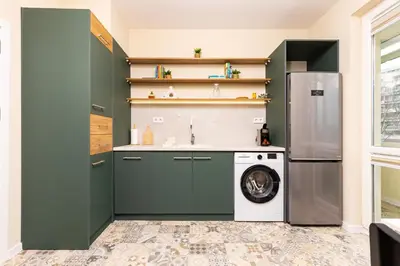 a kitchen with green cabinets and a washing machine at Serene Living in the Heart of Plovdiv by Flat Mаnager in Plovdiv